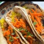 Slow cooker butter chicken tacos with turmeric rice, text overlay showing recipe name
