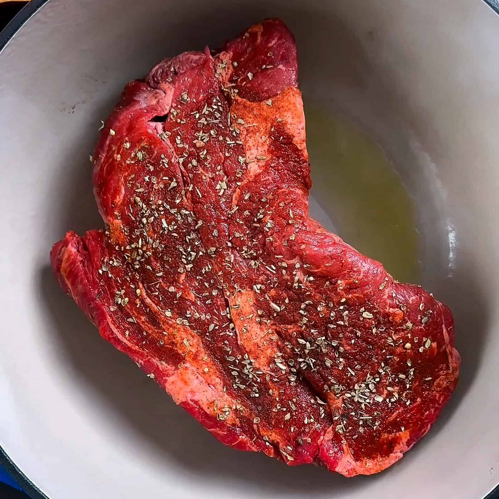 Seasoned raw chuck roast ready for cooking