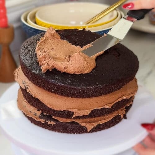 Homemade triple chocolate cake made from scratch with layers of chocolate frosting