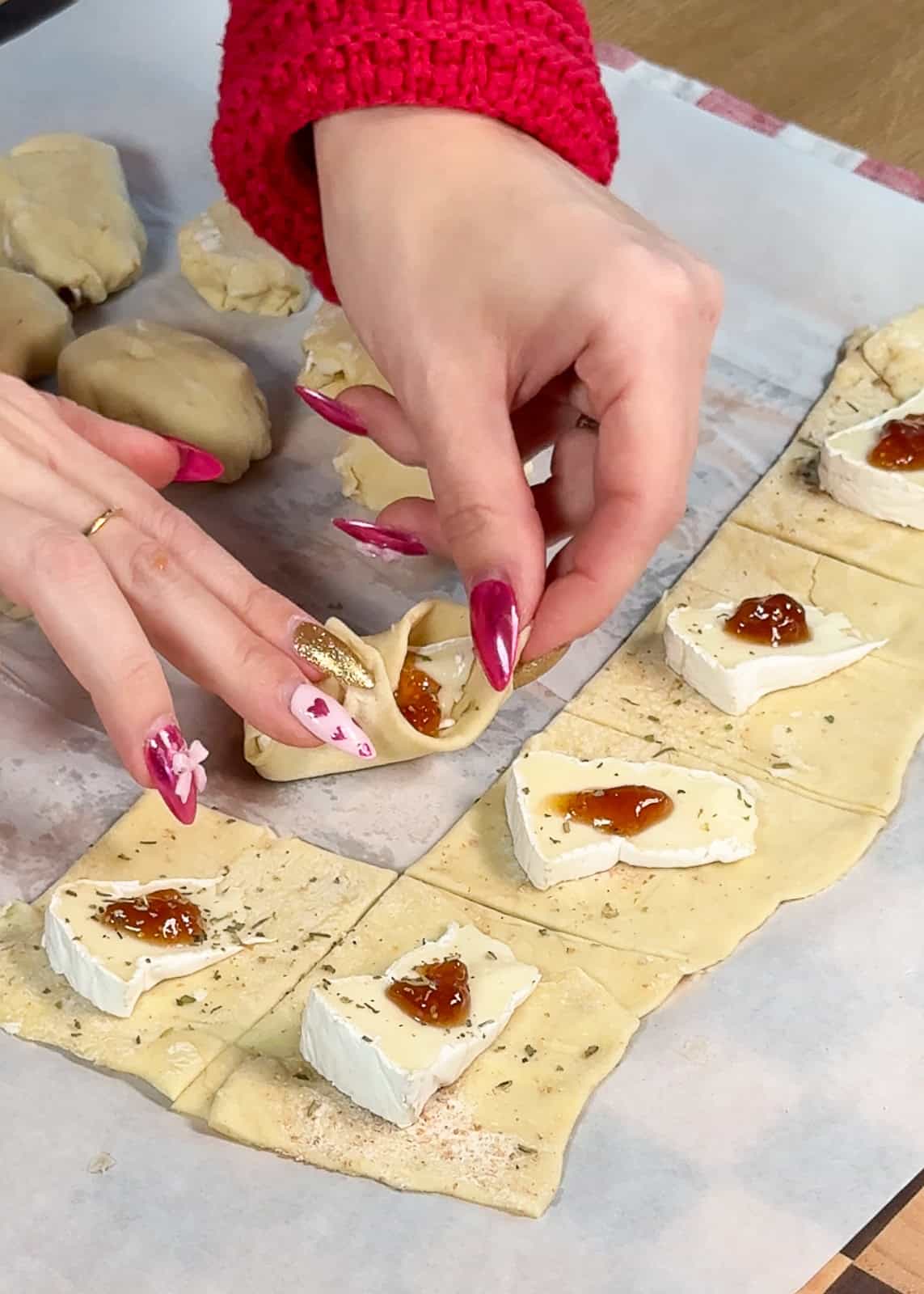 Assembling puff pastry brie and fig bites on a work surface