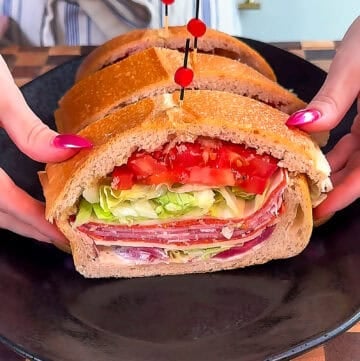 Italian stuffed picnic loaf party sandwich sliced and secured with picks