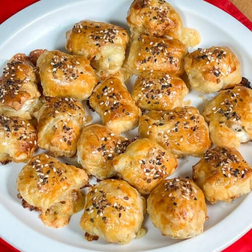 Puff pastry brie and fig bites arranged on a serving platter