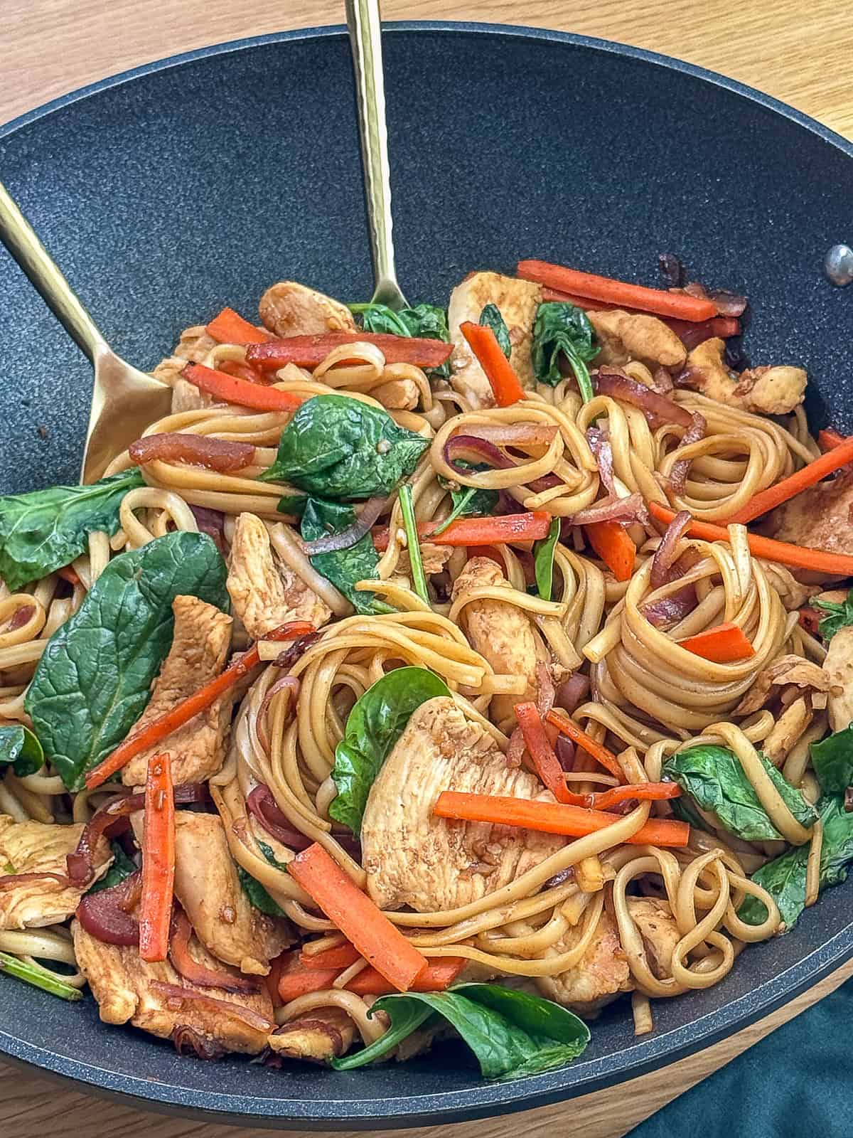 Serving chicken noodle stir fry directly from wok