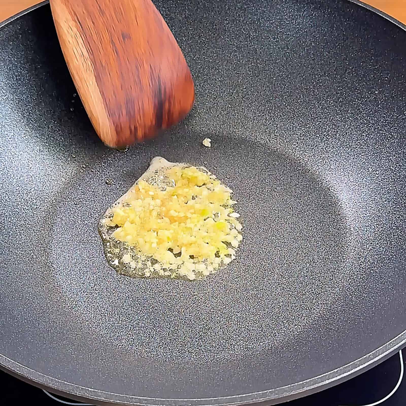 Minced garlic sautéing in hot wok