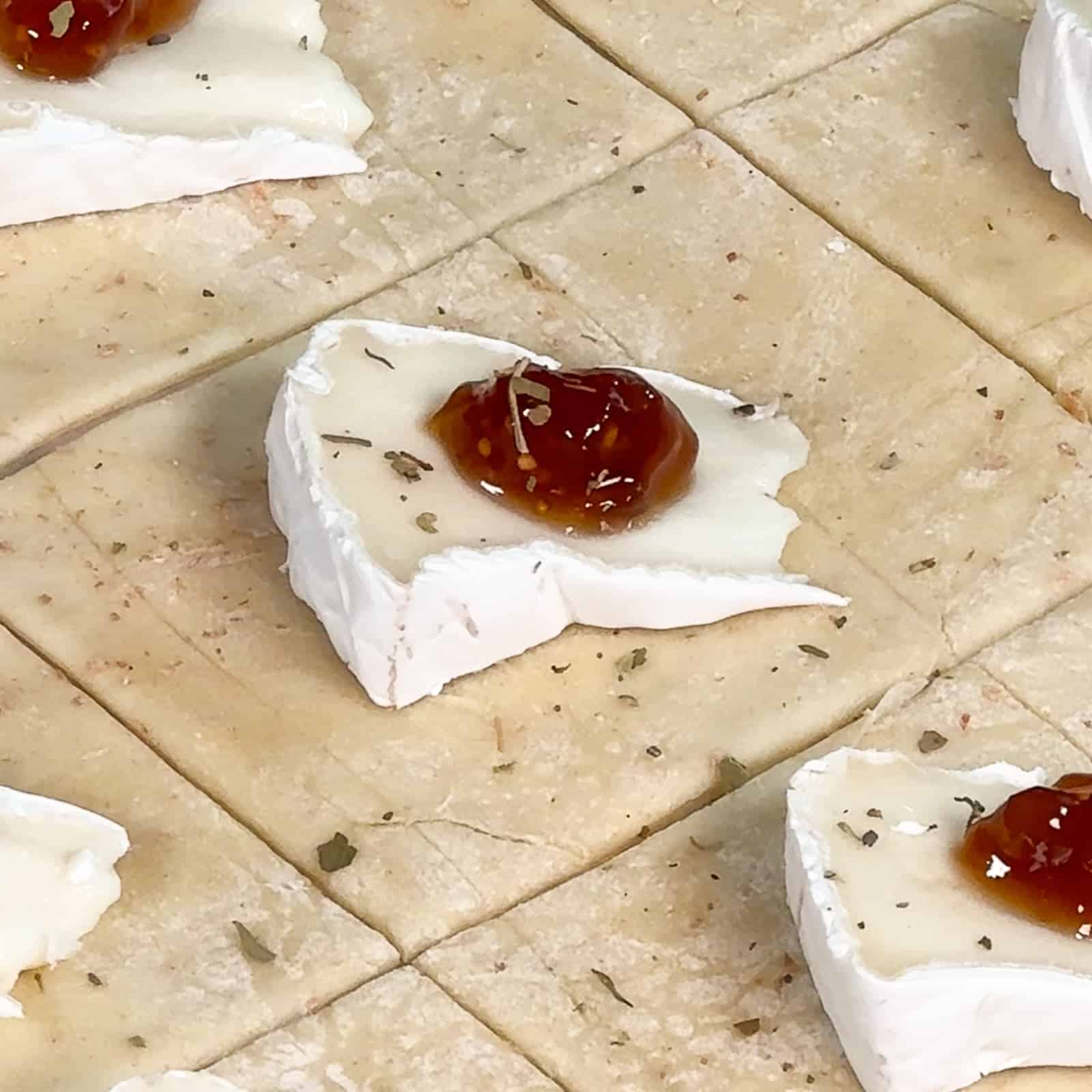 Puff pastry squares topped with brie, fig jam, and Italian seasoning