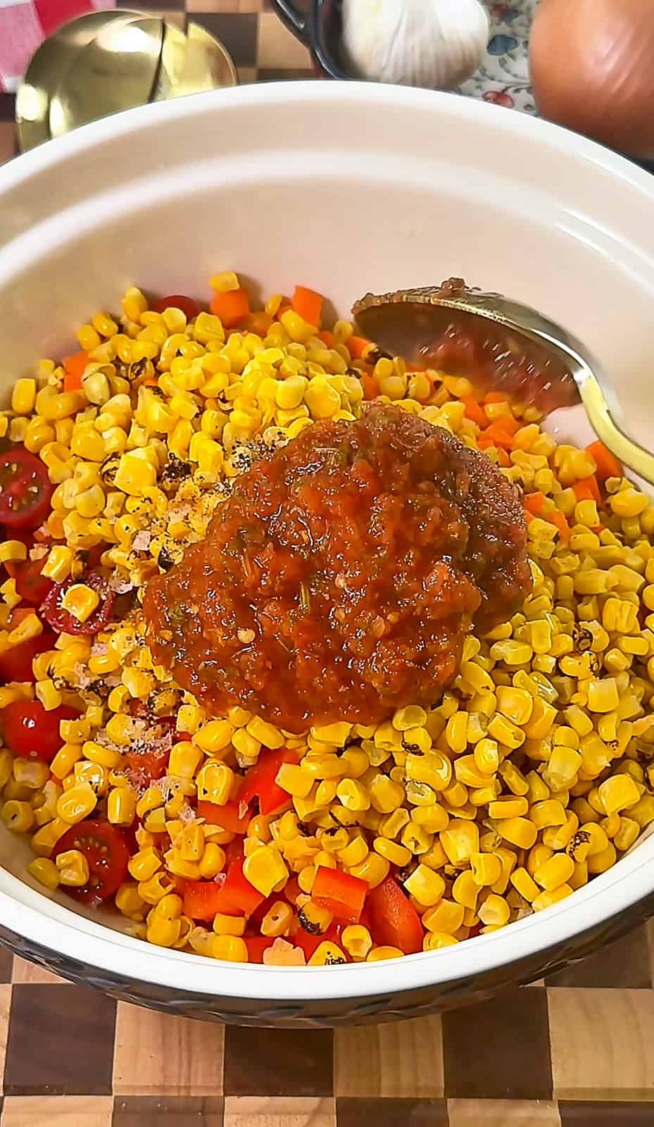 Mixing a bowl of colorful Corn Salsa Dip