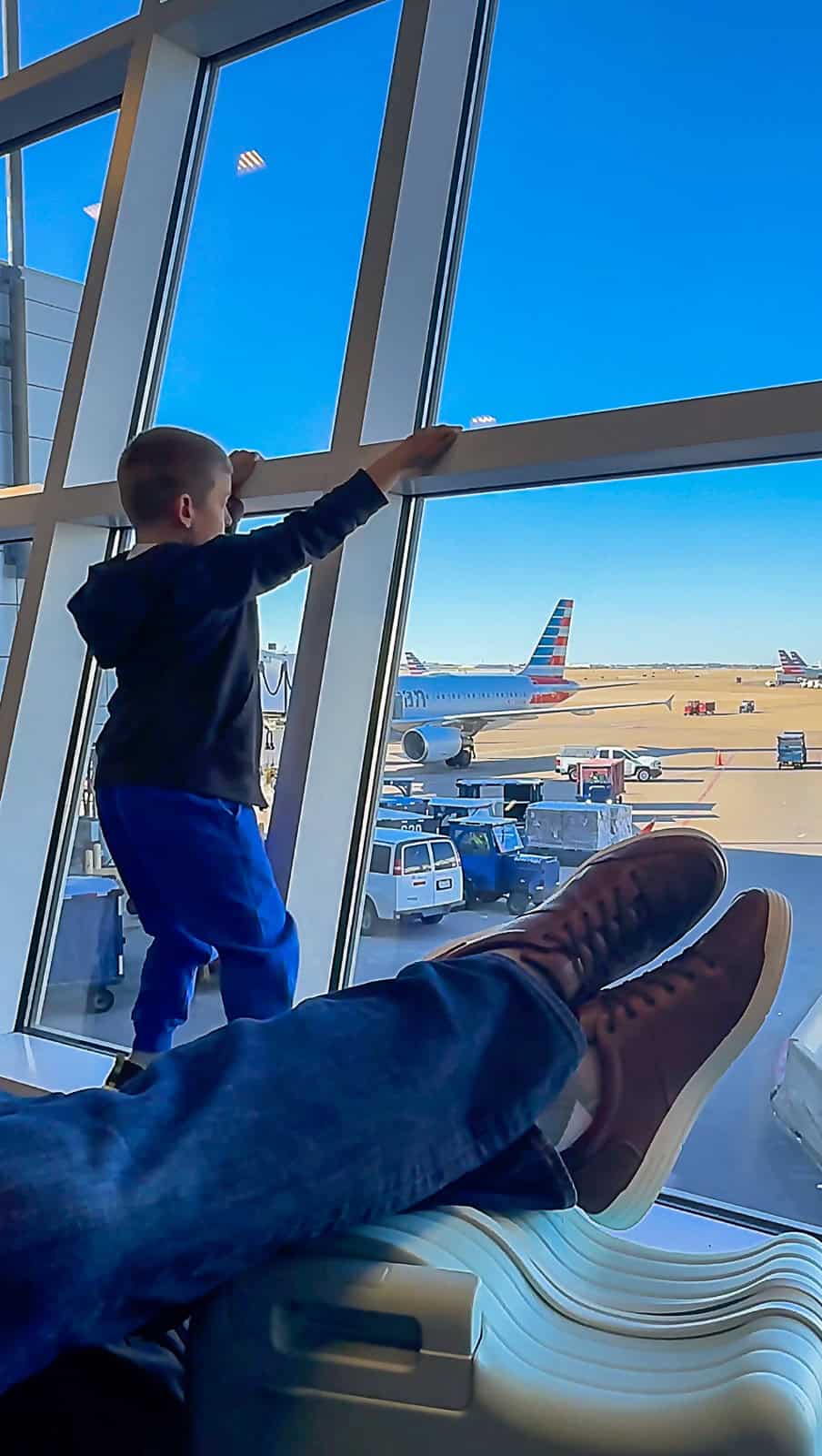 Passenger waiting at airport watching planes take off and land