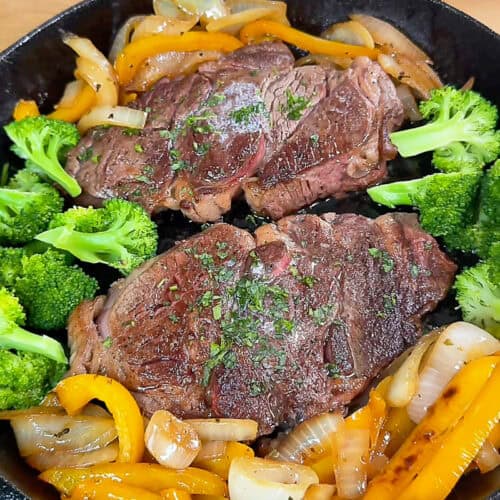 Pan cooked chuck eye steaks with browned crust in skillet