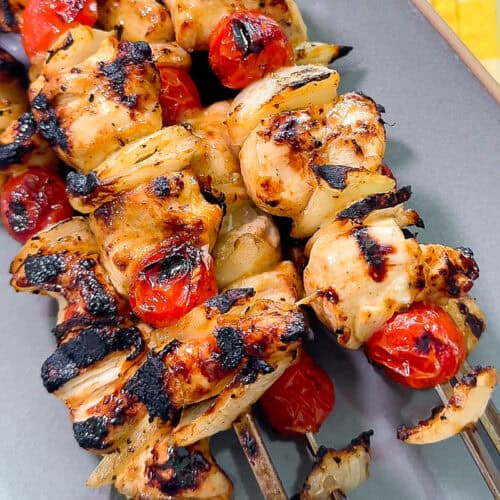 Close-up of grilled BBQ chicken kabobs on skewers