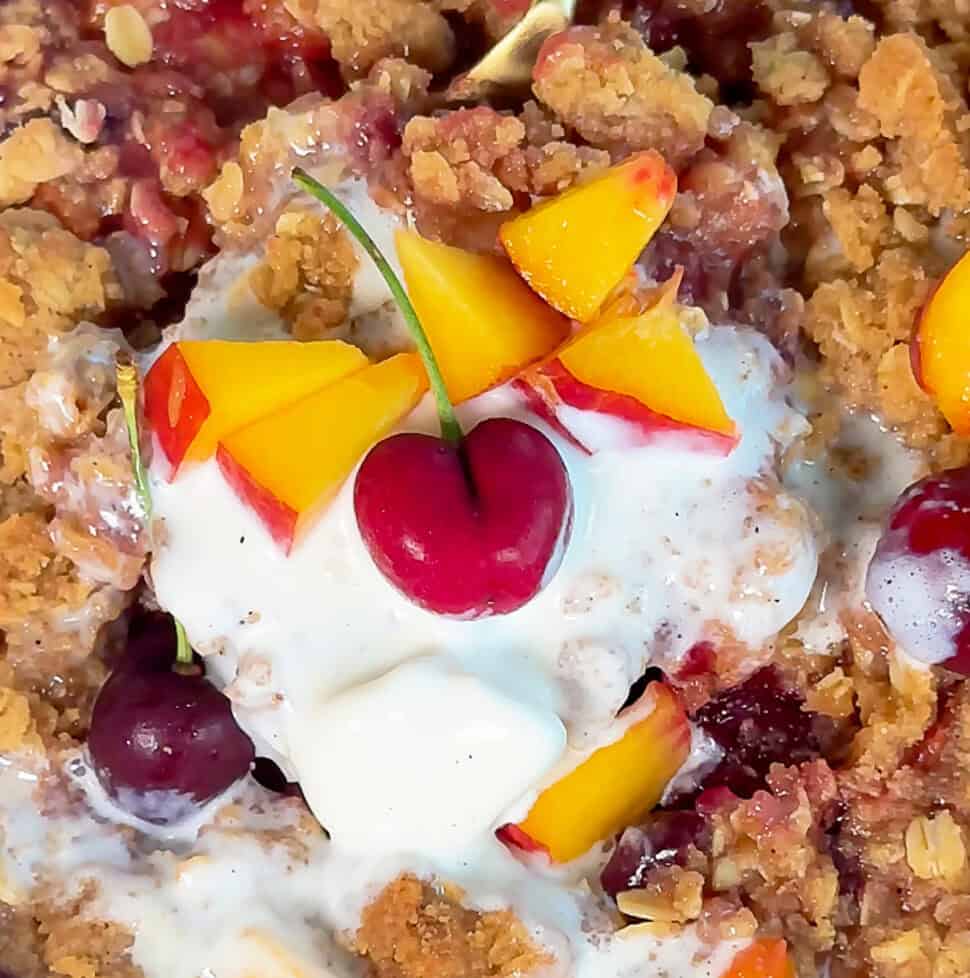 easy cherry peach crisp dessert with vanilla ice cream and fruit topping